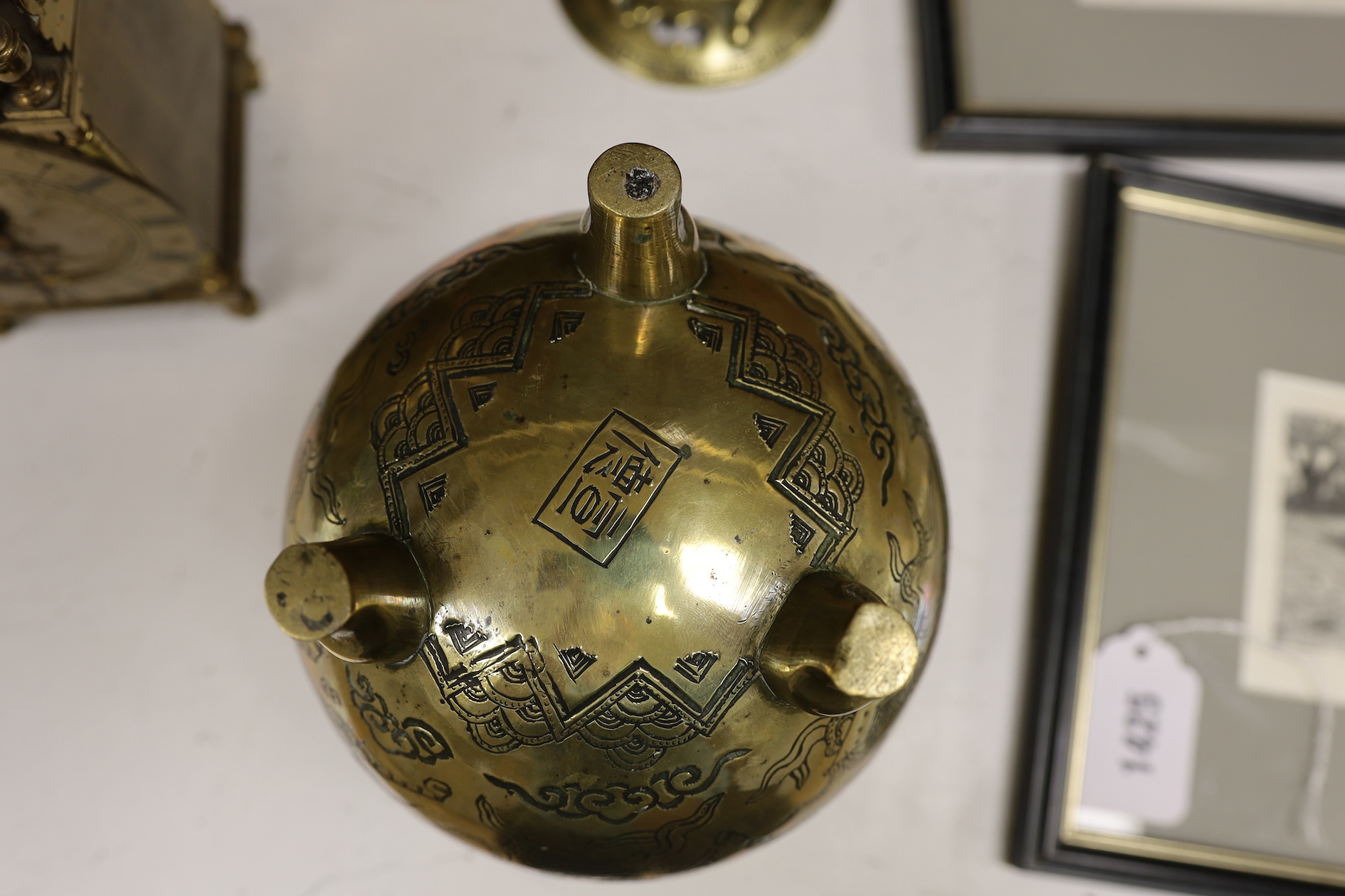 A Chinese bronze globular dragon decorated censer and cover on three legs, Xuande mark, early 20th century, 20cm high. Condition - good